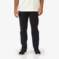 Front view of men's Carrick Stretch Pant paired with black sneakers, showcasing comfortable, beach-inspired casual style.