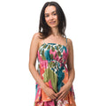 Woman wearing a colorful Eve Cami Top with adjustable straps, beach-inspired comfort and vibrant print on lightweight fabric.