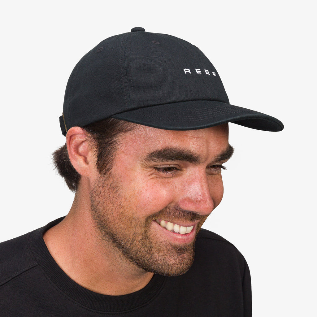 Man wearing a black Schotts Twill Hat facing right, showcasing the front and side with REEF logo on the crown.