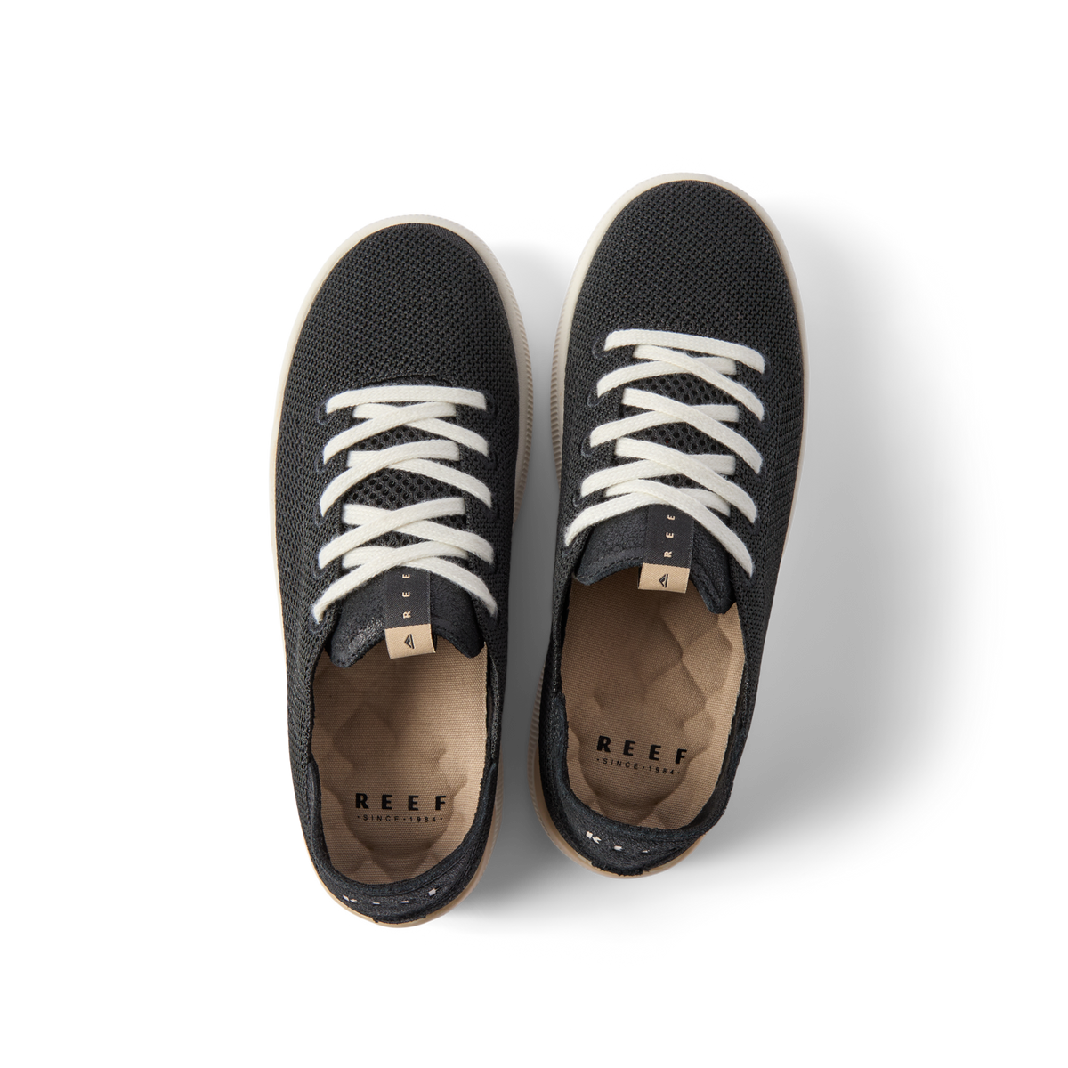 Top view of Reef Neptune women's black sneakers with white laces, featuring arch support and soft cushioning for all-day comfort.