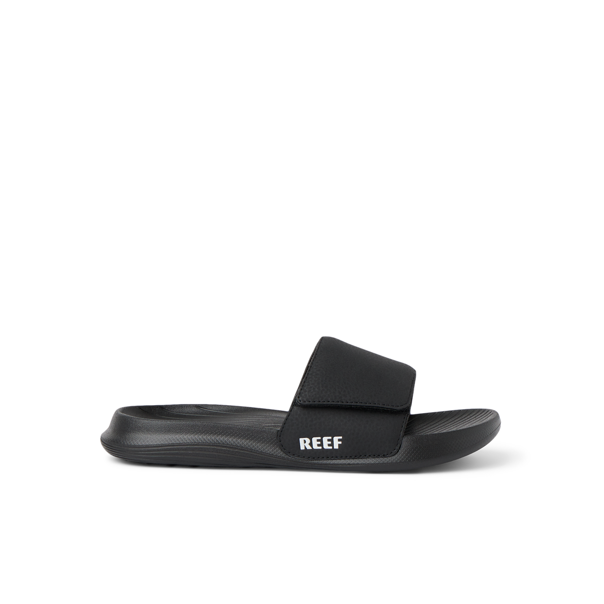 Kids Salty Slide black right-facing side view showing soft-rebound cushioning and anatomical arch support in a beach-inspired slide.