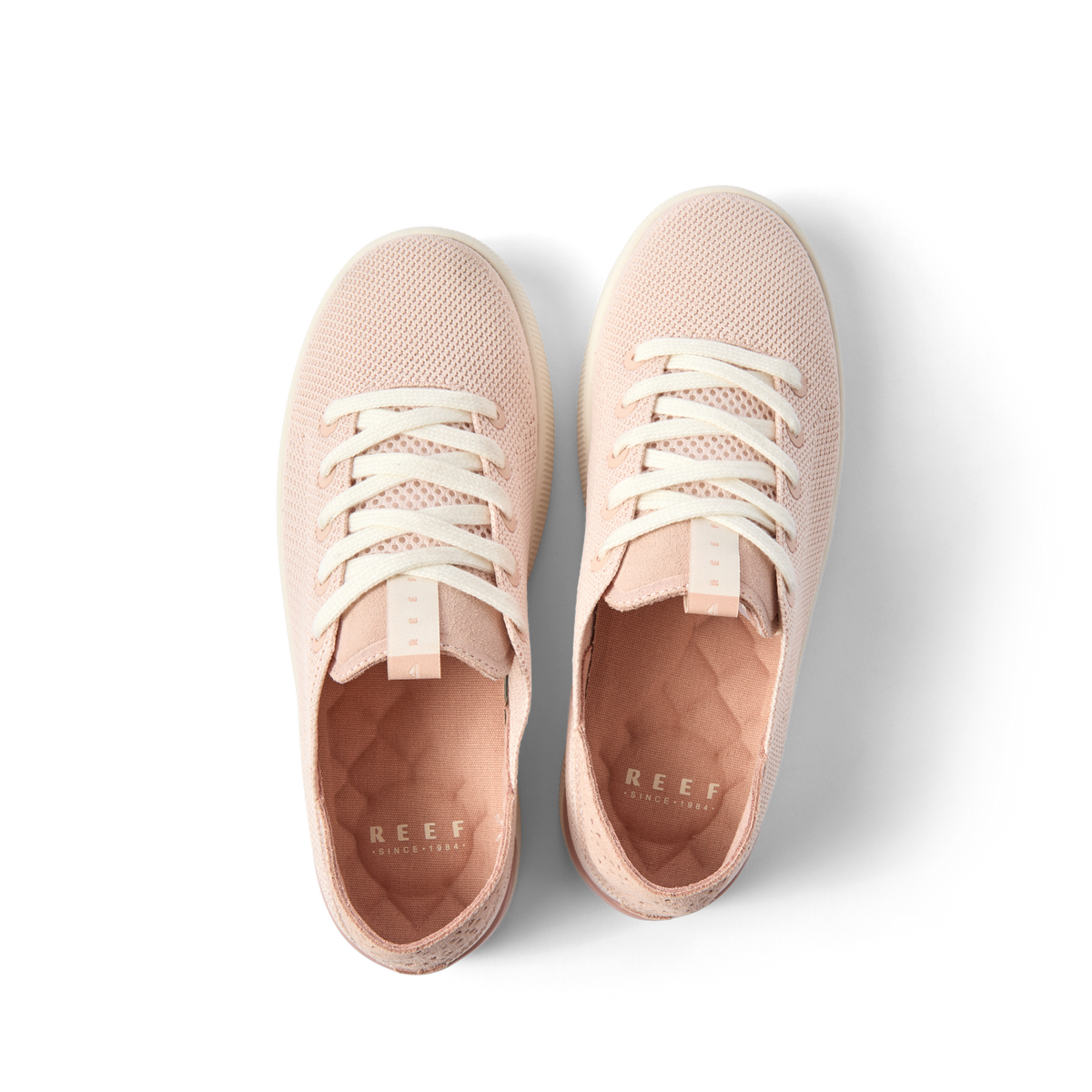 Top view of women's Reef Neptune sneakers in rose blossom with cushioned insoles and breathable mesh uppers.