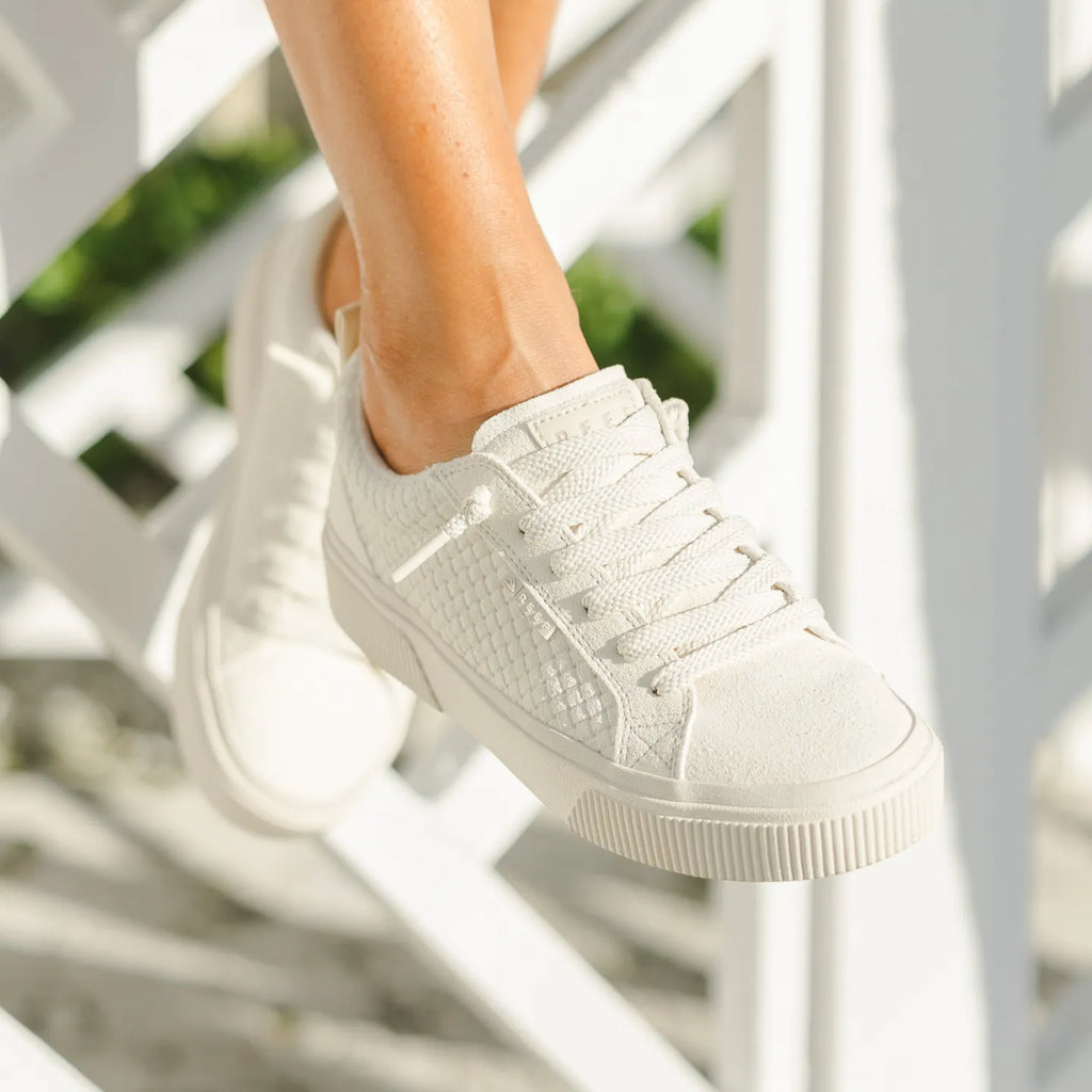 Lay Day Dawn x Jenny women's white sneaker facing forward, showing textured side and lace detail, comfy for everyday wear