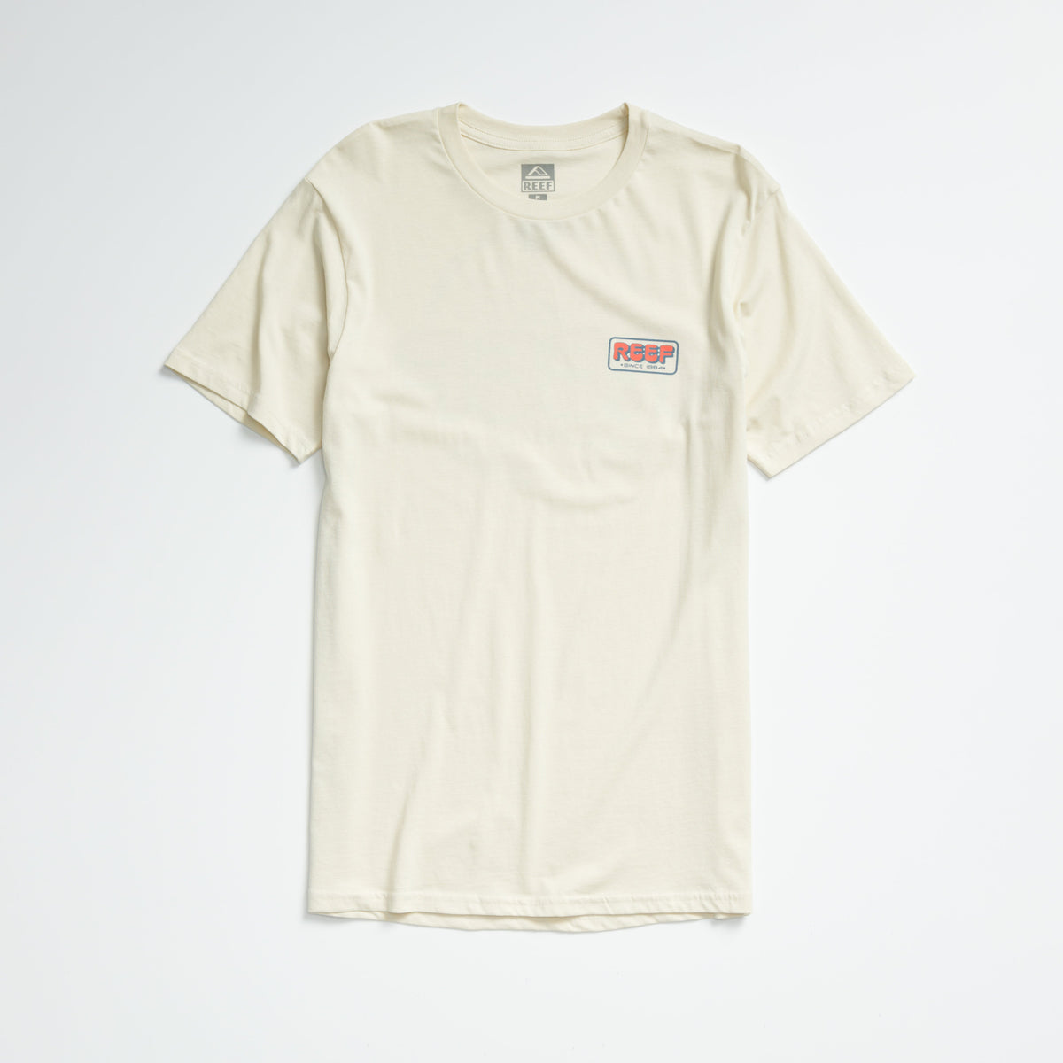 Quinn Tee in almond milk color, laid flat showing front with small REEF logo on chest, lightweight comfort apparel.