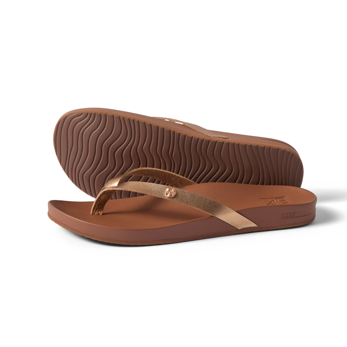 Vista Ivy women's sandals in bronze, side view with sole upward, surf-inspired comfort and anatomical arch support.