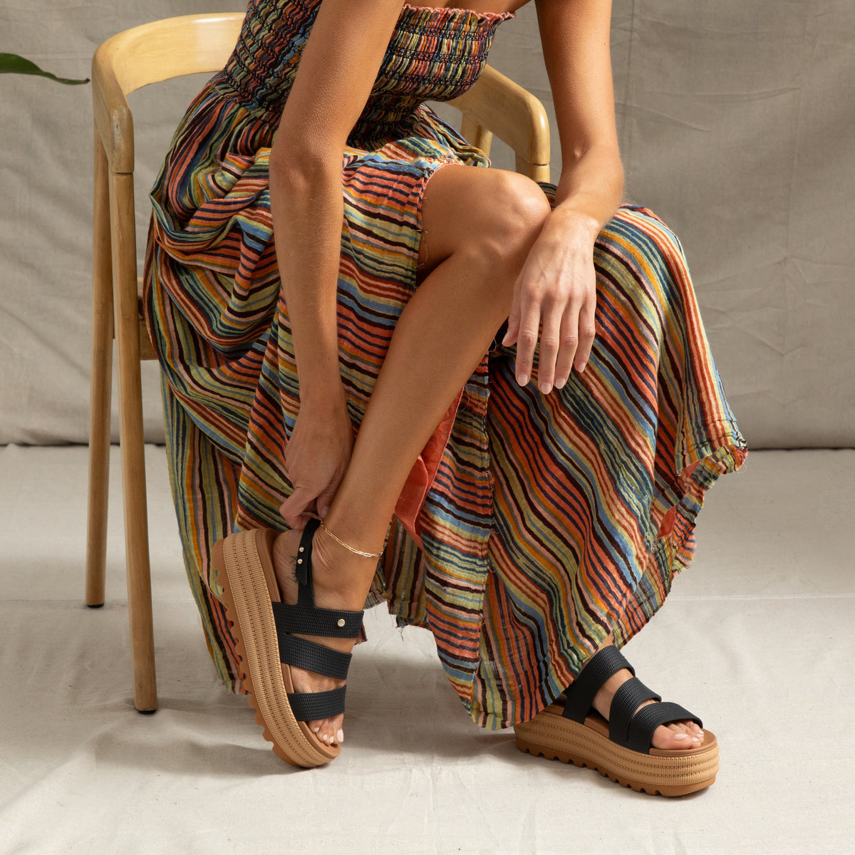 Woman wearing Water Vista Higher 2 sandals facing left, showing side and top with cushioned platform sole and black straps.