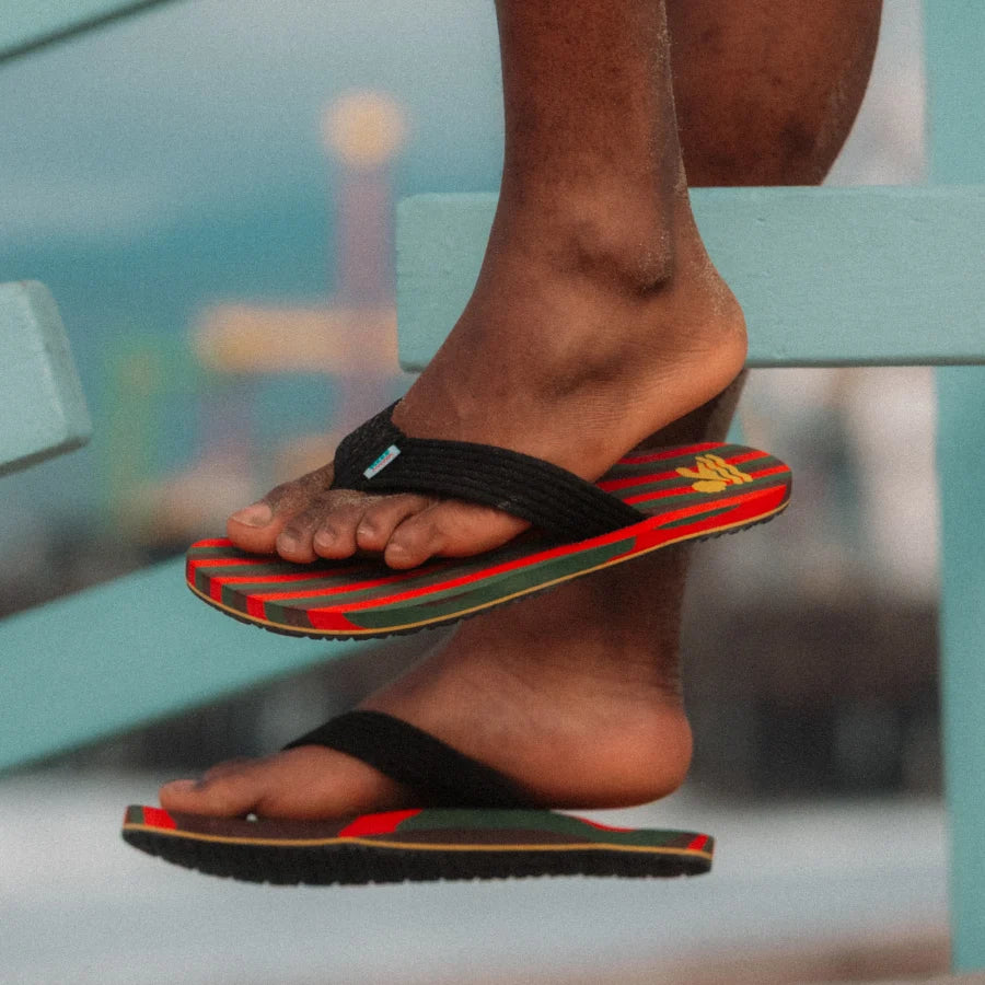 Close-up of feet wearing REEF X Ebony Beach Club Original Stripes sandals facing right with soft-rebound cushioning and arch support.
